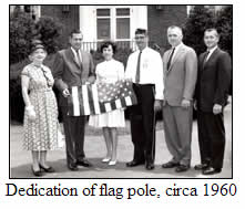 A black-and-white photograph showing the dedication of the flag pole, circa 1960